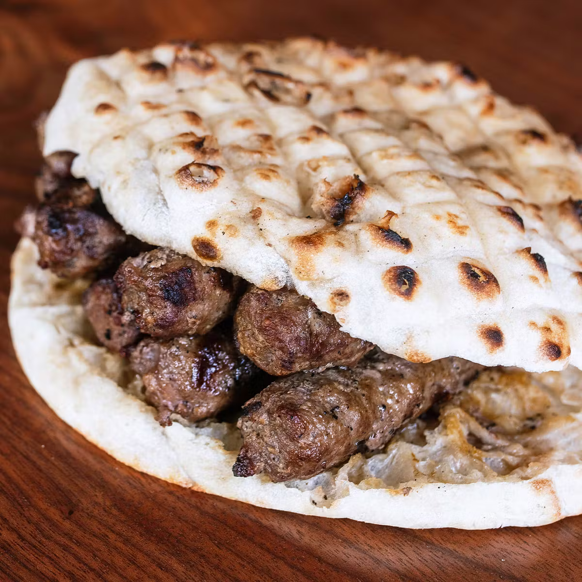 Balkan Treat Box signature dishes Ćevapi (grilled sausages in somun bread), Pide (Turkish-style flatbread), Lahmacun, Doner Kebab, Pljeskavica (Balkan burger).